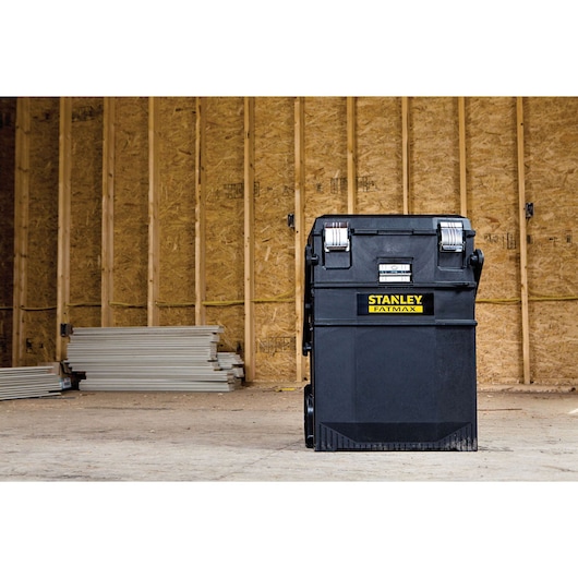 STANLEY 020800R black rolling tool chest with metal latches, photographed in a construction site.