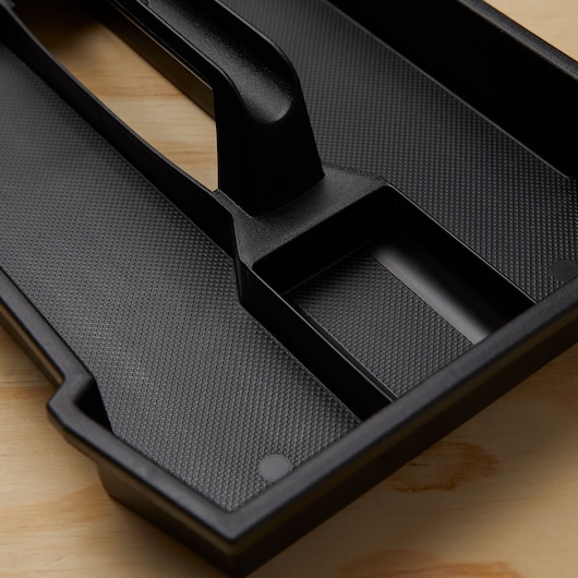 STANLEY SKU 028001L black plastic storage tray close-up with textured surface and divided compartments.