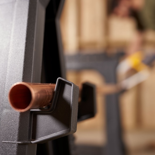 STANLEY 060864R photography of a sawhorse holding a copper pipe, close-up angle.