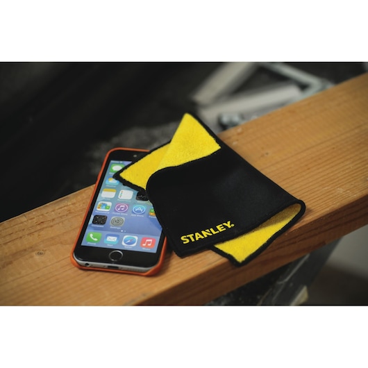 STANLEY 1149000ST2 cleaning cloth, black and yellow, on smartphone, photo shot at angle.