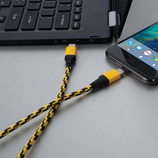 STANLEY 1319596ST2 braided yellow and black USB cable connected to laptop and smartphone, flat lay angle.