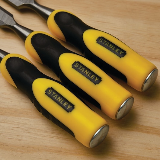 STANLEY 16-300 set of three chisels with yellow and black handles on wooden surface.