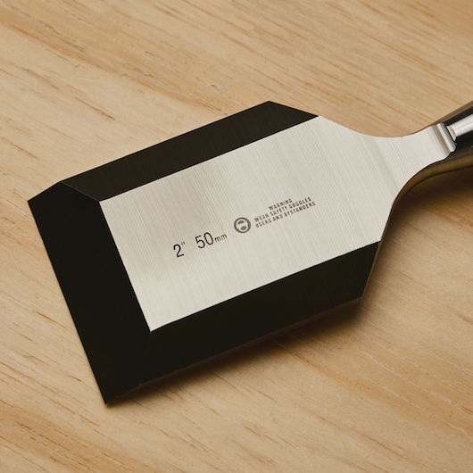 STANLEY chisel 16-981 with 2 inch 50mm blade, close-up photo of beveled edge on wood surface.