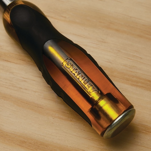 STANLEY 16-981 screwdriver with amber and black handle on wood surface, close-up angle.