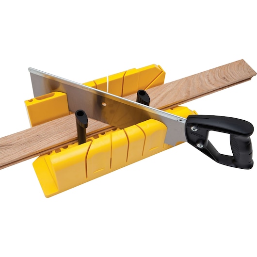 Stanley miter box and saw, yellow plastic with black handle, cutting wood, top angle, photography
