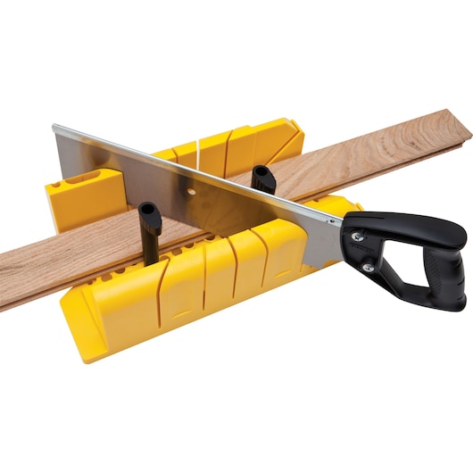 STANLEY 20-600 hand saw with yellow miter box cutting a wooden board, front angle, woodworking tool.