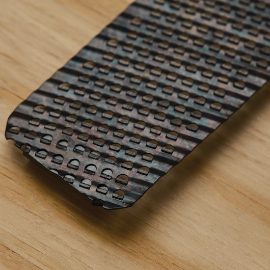 STANLEY 21-293 metal rasp blade with rectangular holes, close-up angle on wood surface.