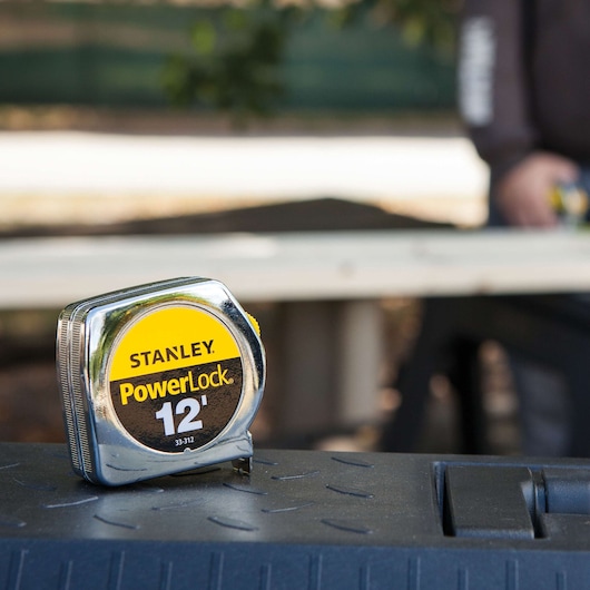 Photo of Stanley PowerLock 12' tape measure 33-312 on a tool box outdoors.