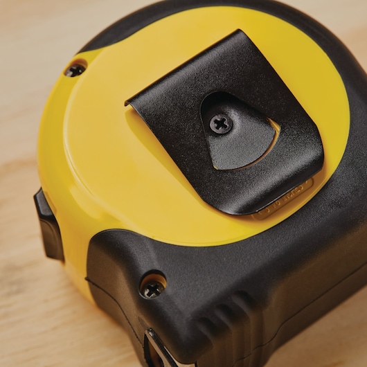 Photo of STANLEY 33-725 tape measure showing yellow and black casing with belt clip, close-up angle.