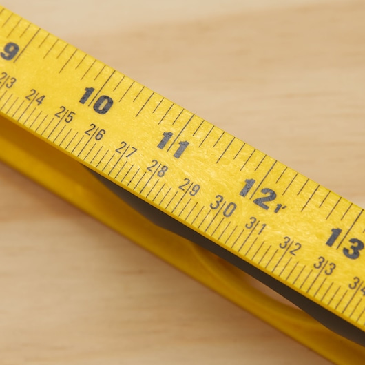 STANLEY tape measure SKU 42-468 close-up showing yellow blade with black markings in inches and fractions.