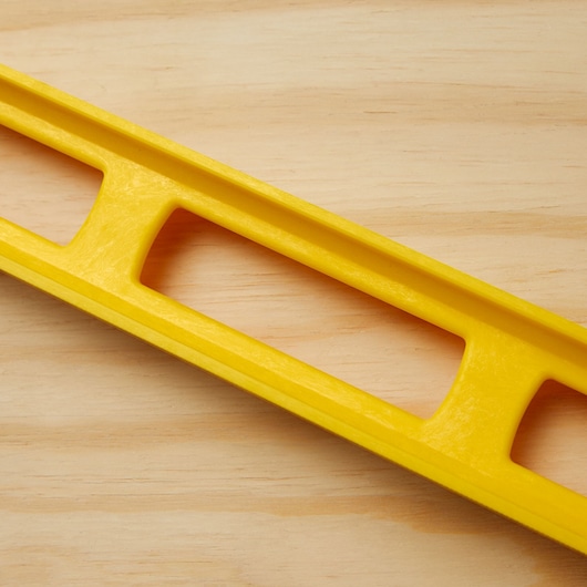 STANLEY 42-470 yellow level tool closeup on light wood surface.