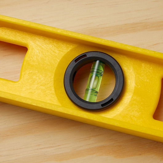 STANLEY 42-470 yellow level close-up showing bubble vial on wood surface.