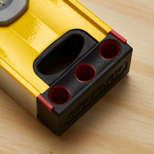STANLEY 43-572 yellow and black level tool with red accents, close-up of handle and vials, on wood surface.