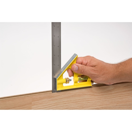 STANLEY 46-131 combination square measuring wood, yellow handle, steel ruler, close-up angle.