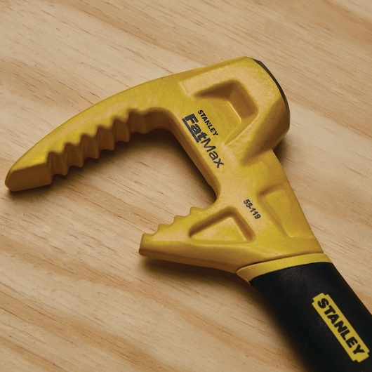Stanley 55-119 FatMax yellow utility bar with serrated edge, close-up on wooden surface