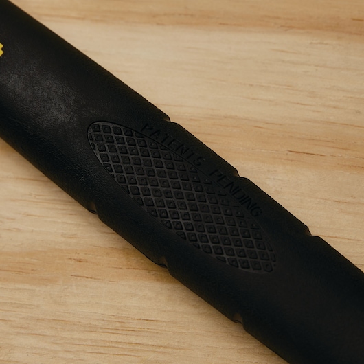 STANLEY 55-119 tool handle close-up with black textured grip and 'PATENTS PENDING' text, on wood surface.