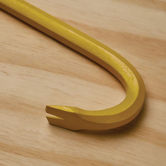STANLEY 55-136 yellow steel pry bar, photographed close-up on wood surface.