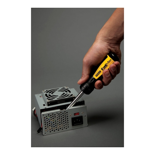 STANLEY 69-189 screwdriver used to repair an electronic device, close-up angle, yellow and black handle.
