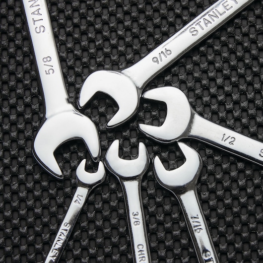 Photo of STANLEY 85-927 chrome open-end wrenches assorted in a fan on textured black surface.
