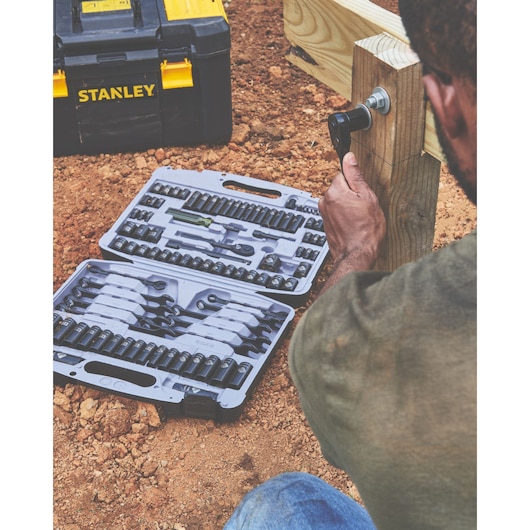 STANLEY 92-839 socket wrench set in open case beside toolbox, used outdoors on construction site.