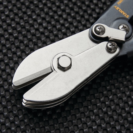 STANLEY FMHT73568 compound action aviation snip close-up on textured black surface.