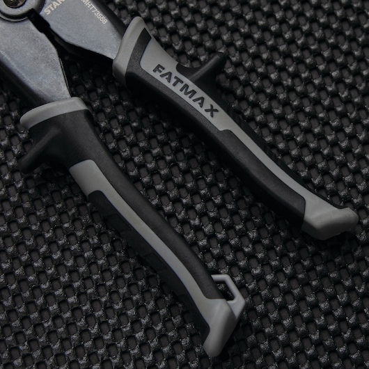 STANLEY FMHT73568 FATMAX black and gray plier handles on textured black surface.