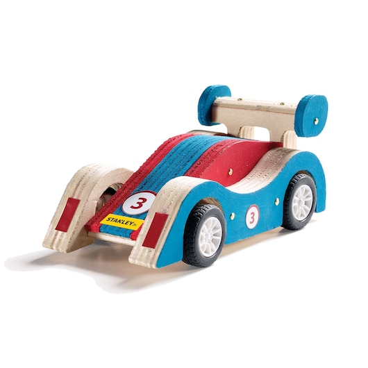 Stanley wooden race car toy, side angle, blue and red paint, number 3 decals, white wheels, white background