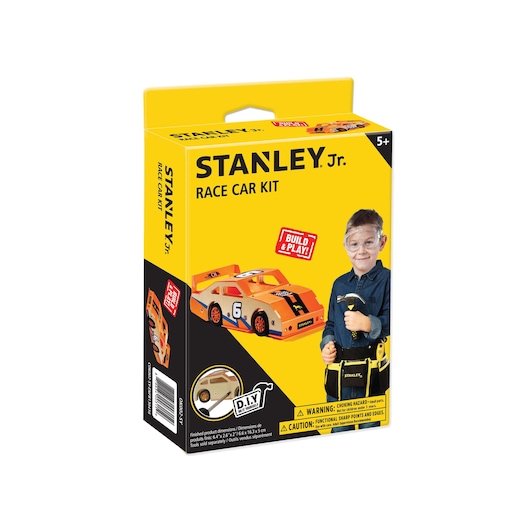 Front angle of STANLEY Jr. race car kit box with yellow background, toy car image, and child holding tools