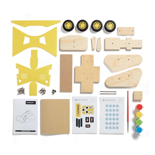 Stanley photography kit components on white background, including yellow plates, wooden parts, wheels, paint, stickers.