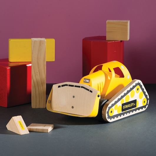 STANLEY OK005-SY wooden toy excavator with yellow parts and blocks, front angle photo.