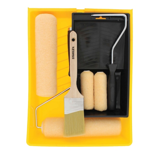 Top-down view of STANLEY paint roller set with yellow tray, black paint tray, brush, and rollers on white background.