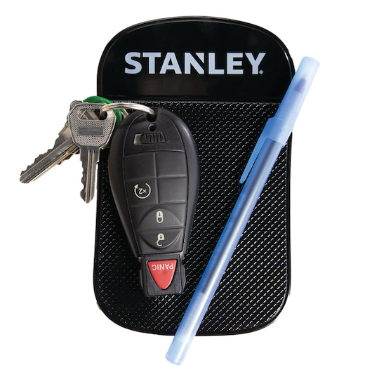 Stanley dashboard holder with car keys, black remote and blue pen, front angle on white background