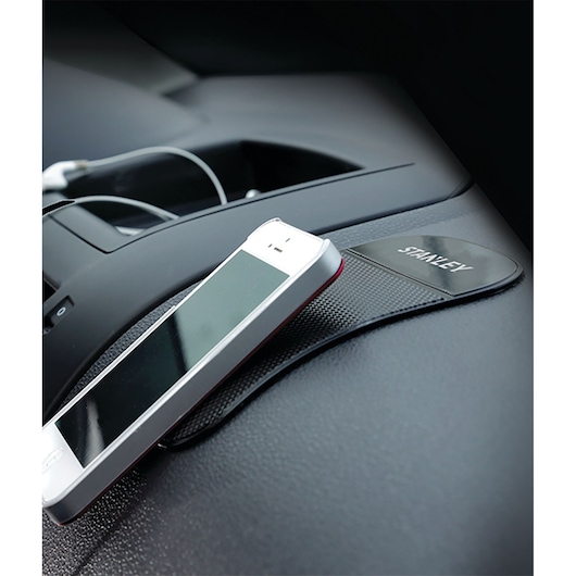 STANLEY S4006 non-slip dashboard mat holding a smartphone, photography from above.
