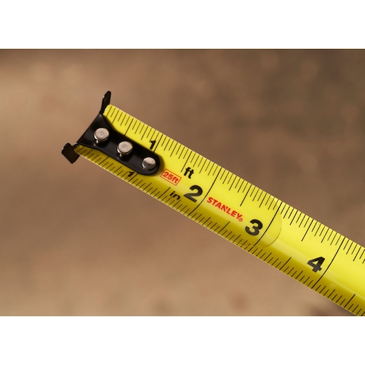 STANLEY STHT37244 yellow tape measure close-up showing black tip and clear measurement markings.