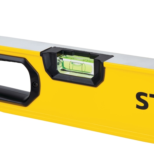 STANLEY STHT42496 yellow spirit level close-up with bubble vial and ergonomic handle, side angle.