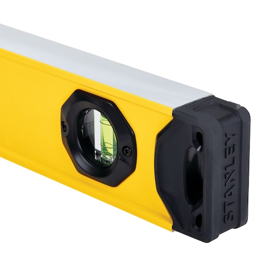 STANLEY STHT42504 yellow spirit level with rubber end cap, close-up on white background.