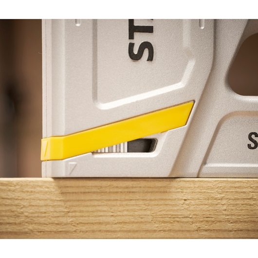Photo of STANLEY STHT70150 photography, silver tool with yellow accent resting on wood.