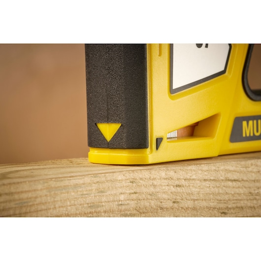 STANLEY STHT70440 yellow and black tool close-up on wood surface, sharp angled view.