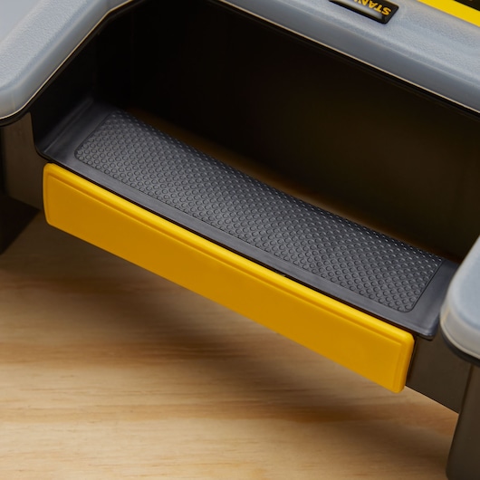 STANLEY STST14027 photography of textured black and yellow step on storage unit close-up.