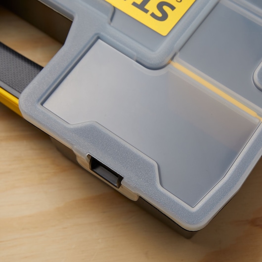 Photo of STANLEY STST14027 organizer with clear plastic lid and black latch on wood surface.