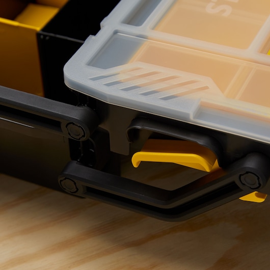 STANLEY STST14028 organizer close-up, showing transparent lid, yellow latch, and black handle.