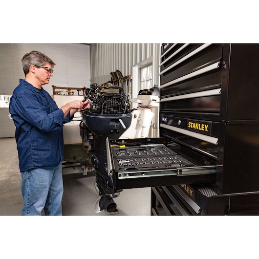 STANLEY STST22625BK tool chest with open drawer, black finish, workshop setting, side angle.