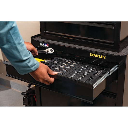 Photo of STANLEY STST22656BK tool chest drawer open, showing organized socket set, ratchet, and pliers inside.