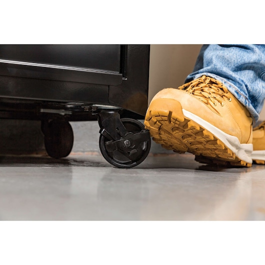STANLEY STST22656BK tool chest caster wheel with foot brake, close-up angle.