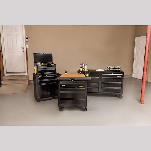 STANLEY STST23151BK black metal tool chests with drawers, photographed in garage setting, front angle.
