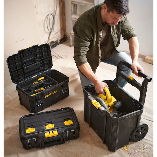 Photo of STANLEY STST60500 toolboxes and mobile chest with yellow latches, used in a construction setting.