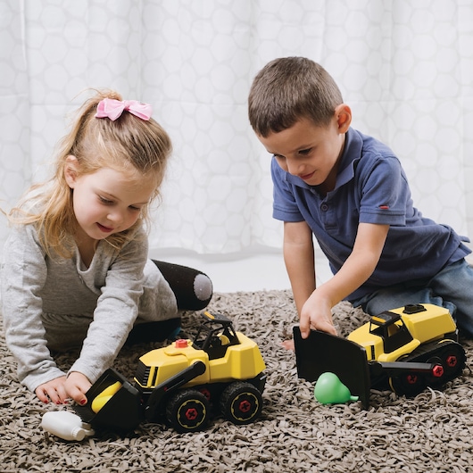 STANLEY TT005-SY kids playing with yellow toy bulldozers on carpet, front angle, Photography.